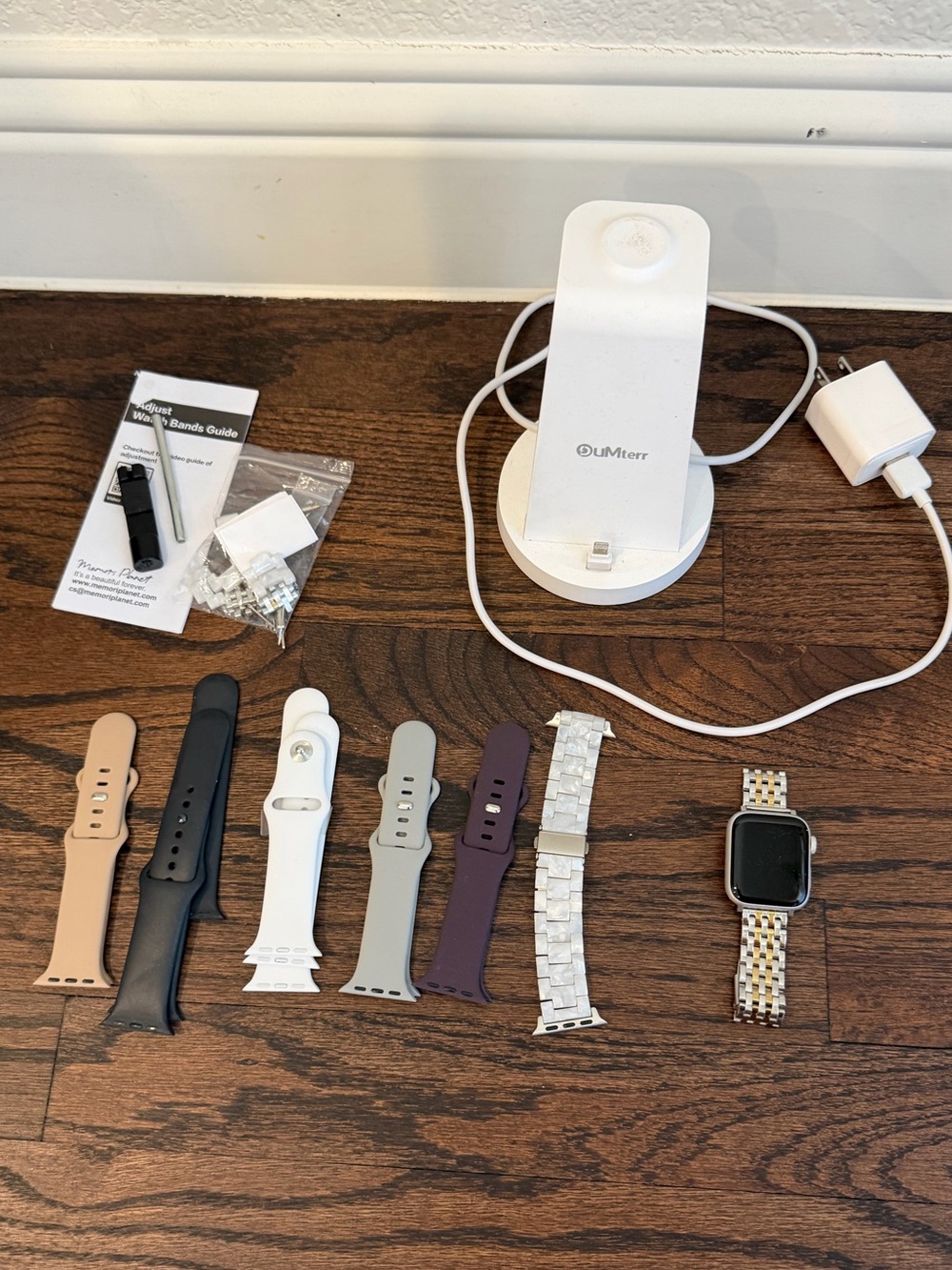 Apple Smartwatch with Multiple Colored Bands and Charging Stand